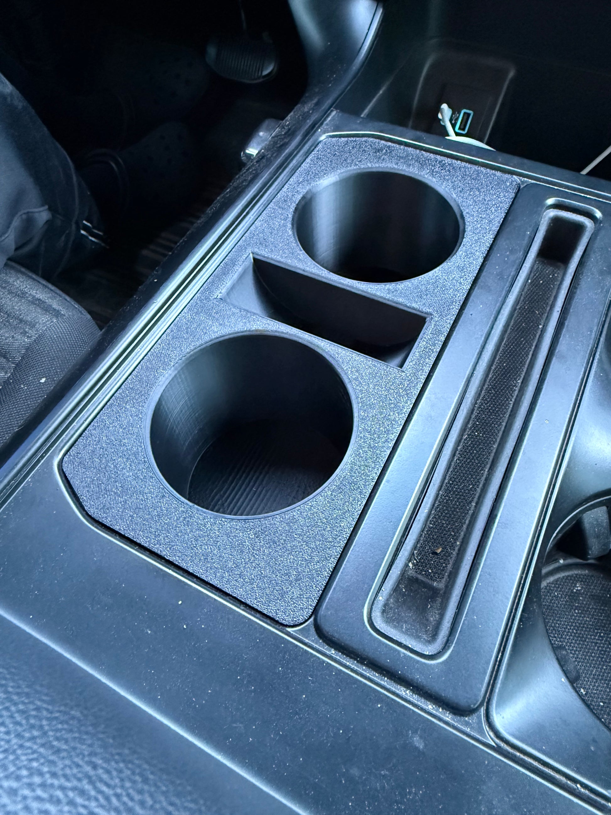 Custom black Ford F-150 double cup holder insert with OEM-style textured finish and precision fit