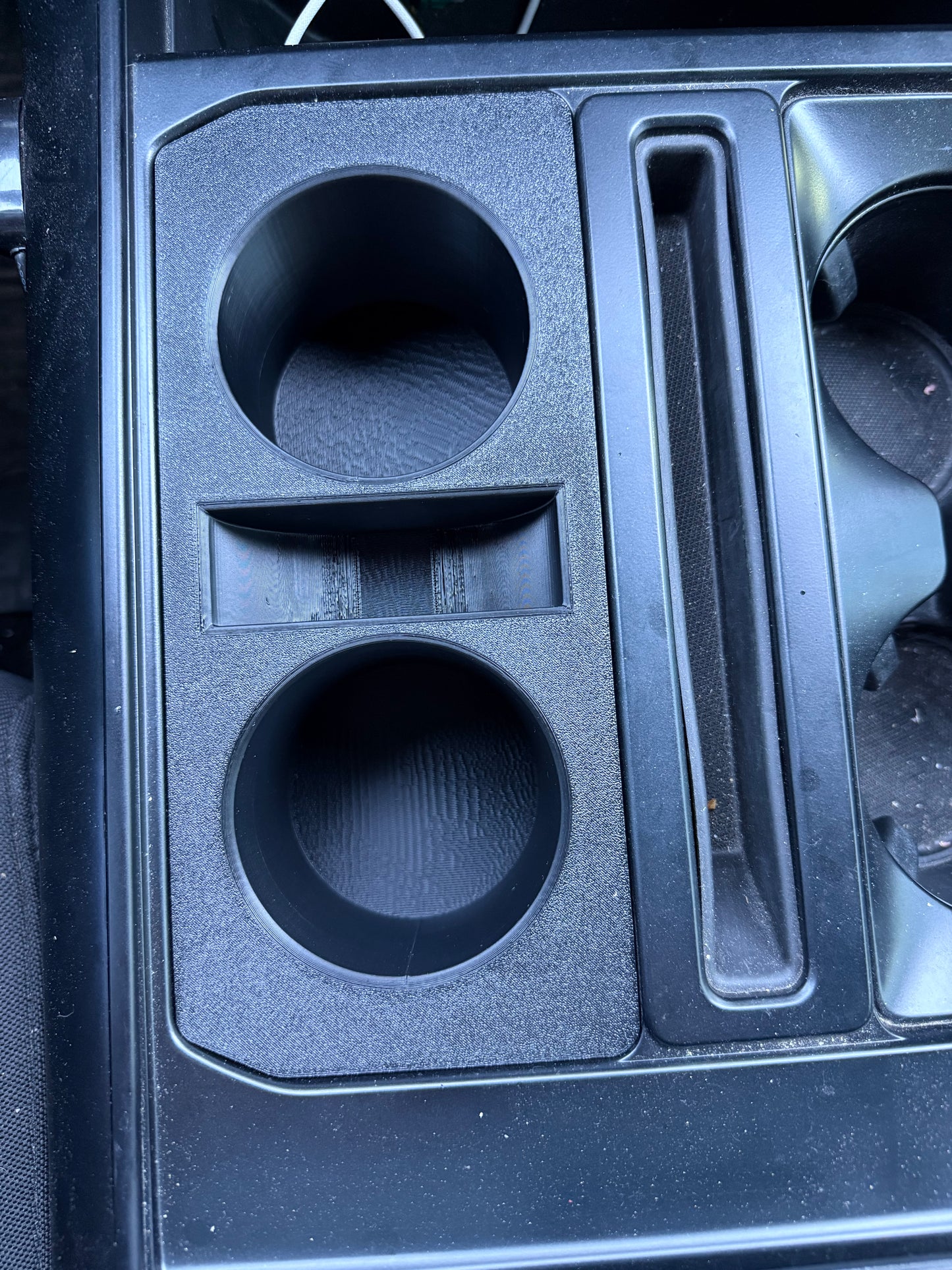 Ford F-150 center console organizer with dual cup holders and utility storage compartment