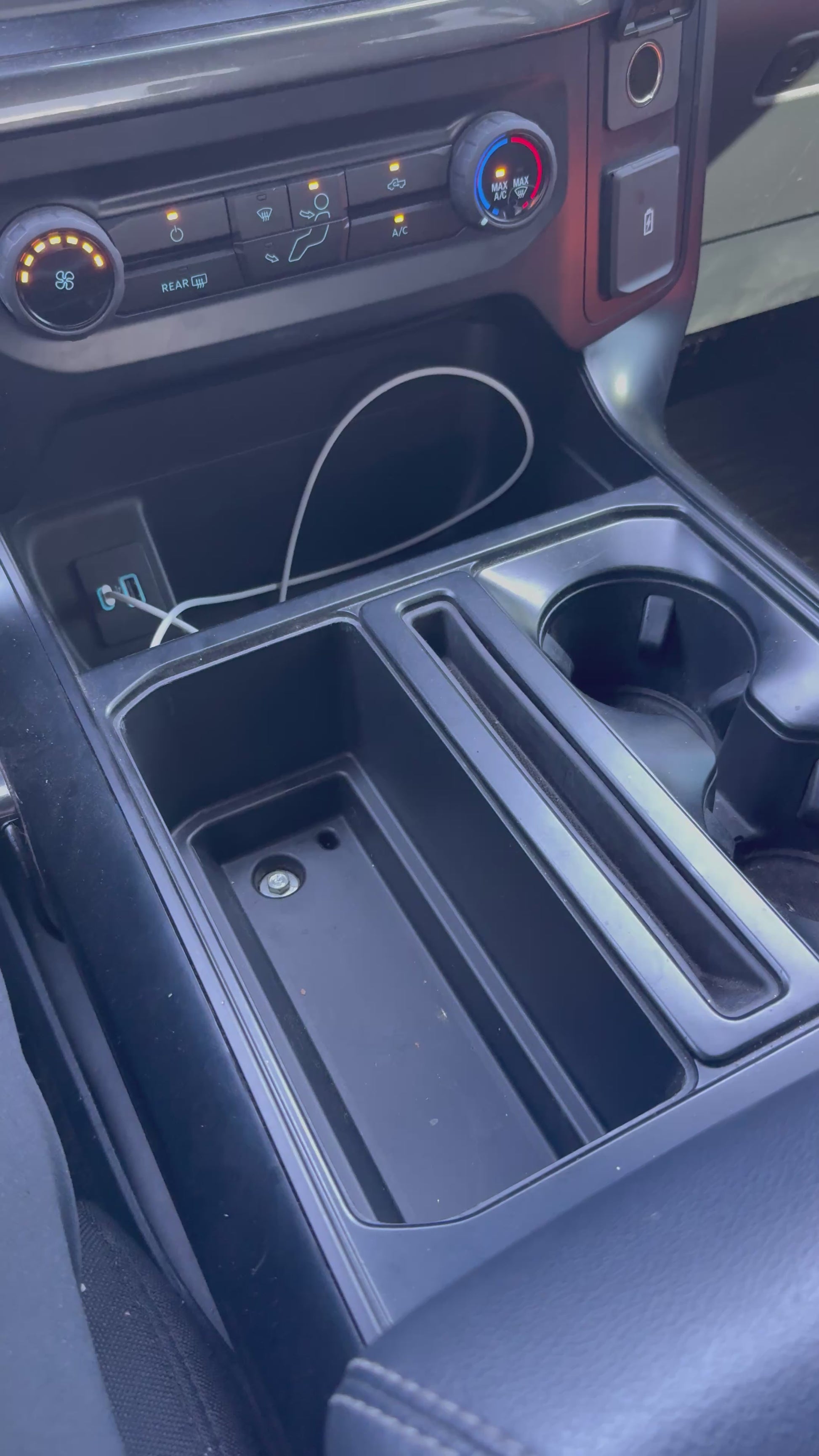 2021–2026 F150 console organizer demonstrating cup holder, sidearm compartment, and utility storage layout